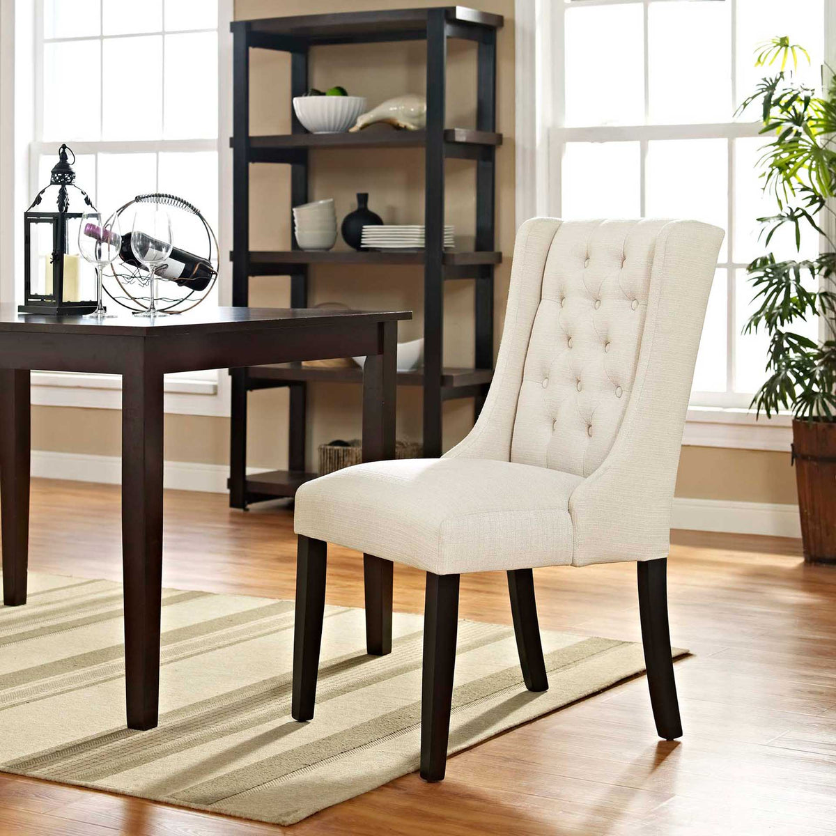Beige button-tufted dining chair adds soft texture and an elegant curved back to the dining room
