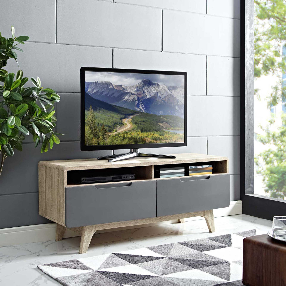 Low-profile TV stand keeps a screen above open component shelves and two gray drawers