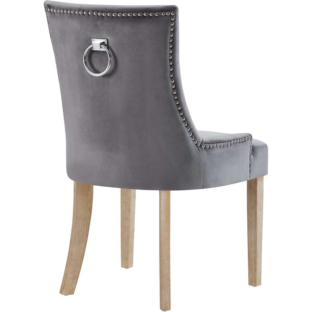 A gleaming metal ring punctuates the gray velvet back, framed by studded trim and natural wood legs