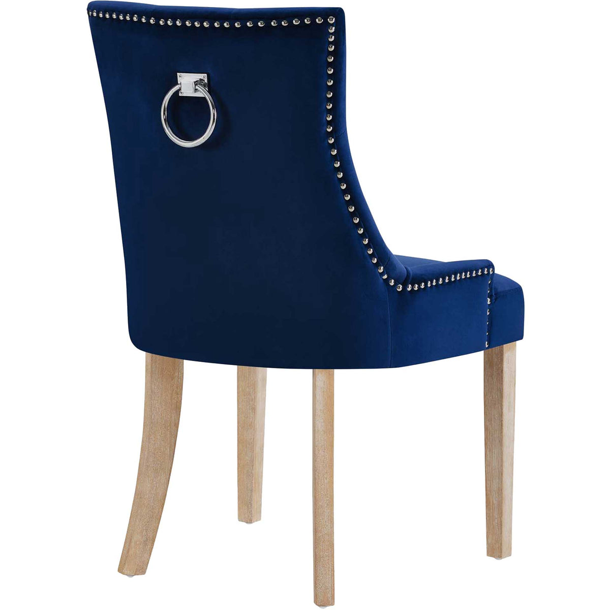 A polished metal ring stands out against the navy velvet chair back, bordered by silver nailheads