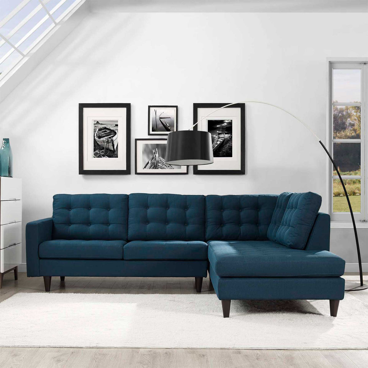 Blue sectional brings a plush right-side chaise and tufted loveseat seating into a bright living room