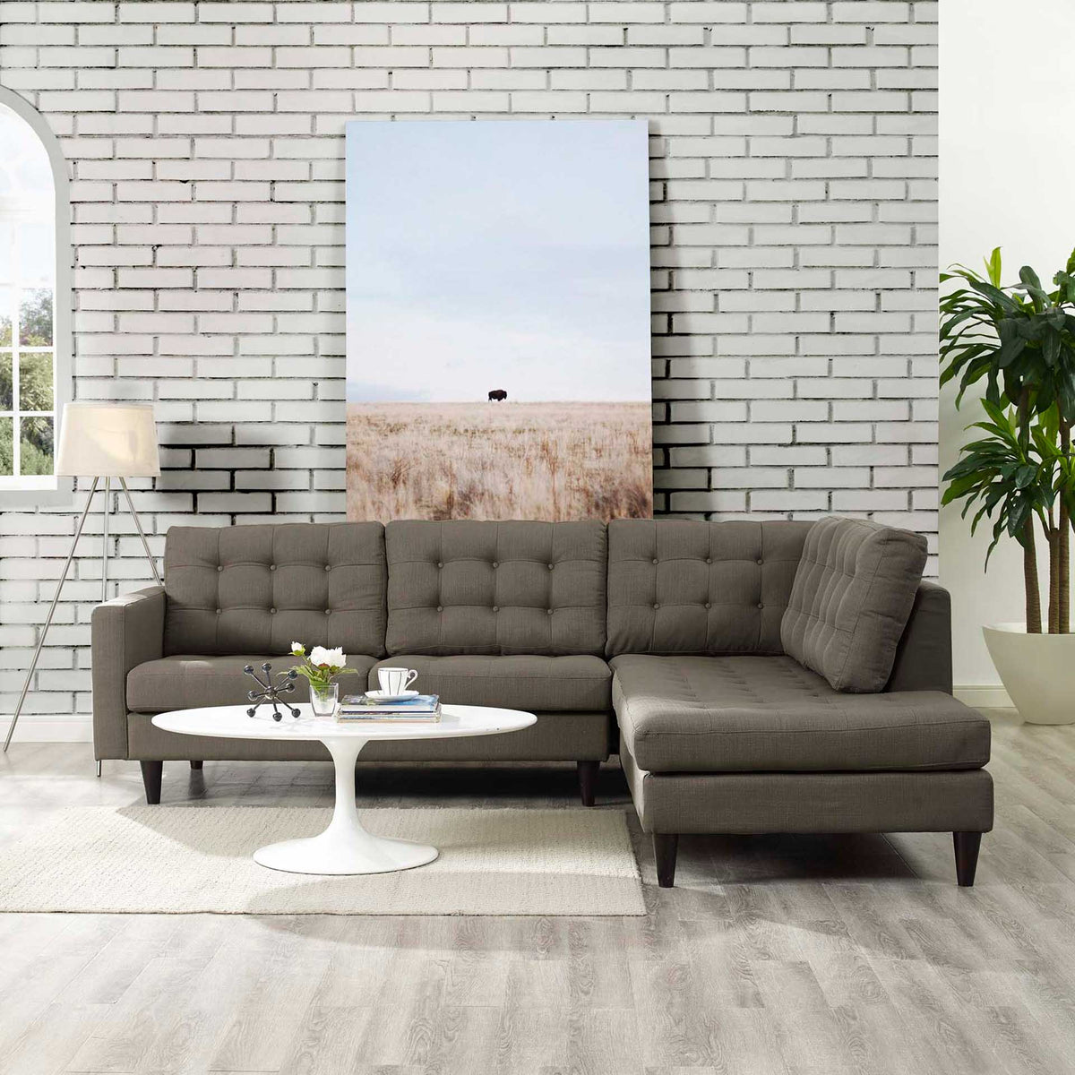 Gray sectional adds soft tufting and a roomy right-hand chaise to a bright living space