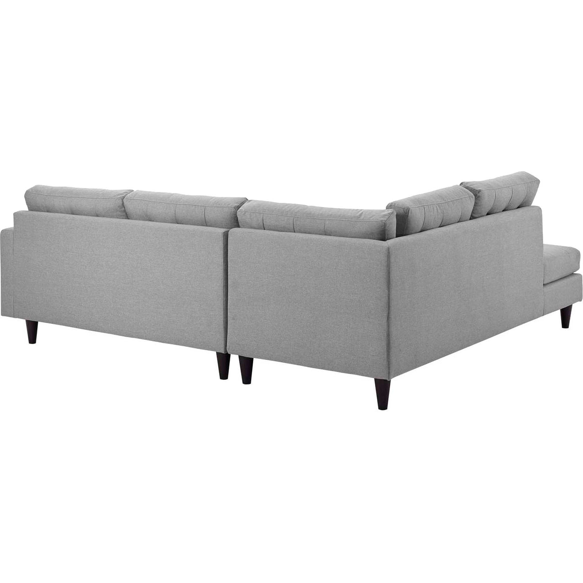 Soft gray upholstery covers the sectional's tailored outer backs above dark wood feet