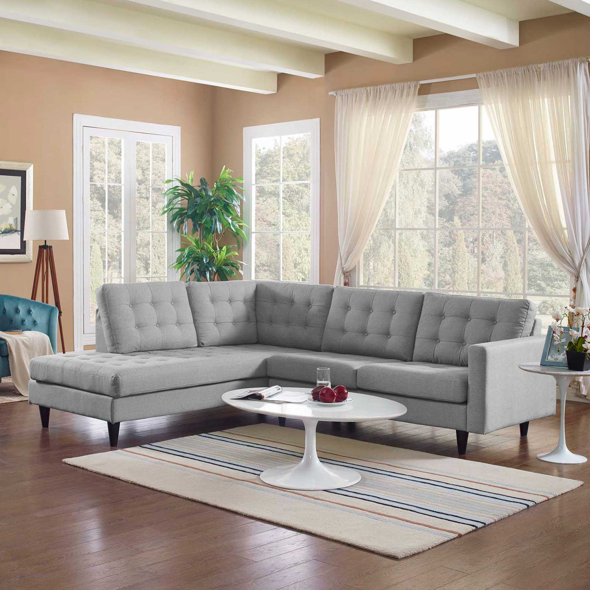 Light gray sectional brightens the living space with plush tufted seating and a generous chaise
