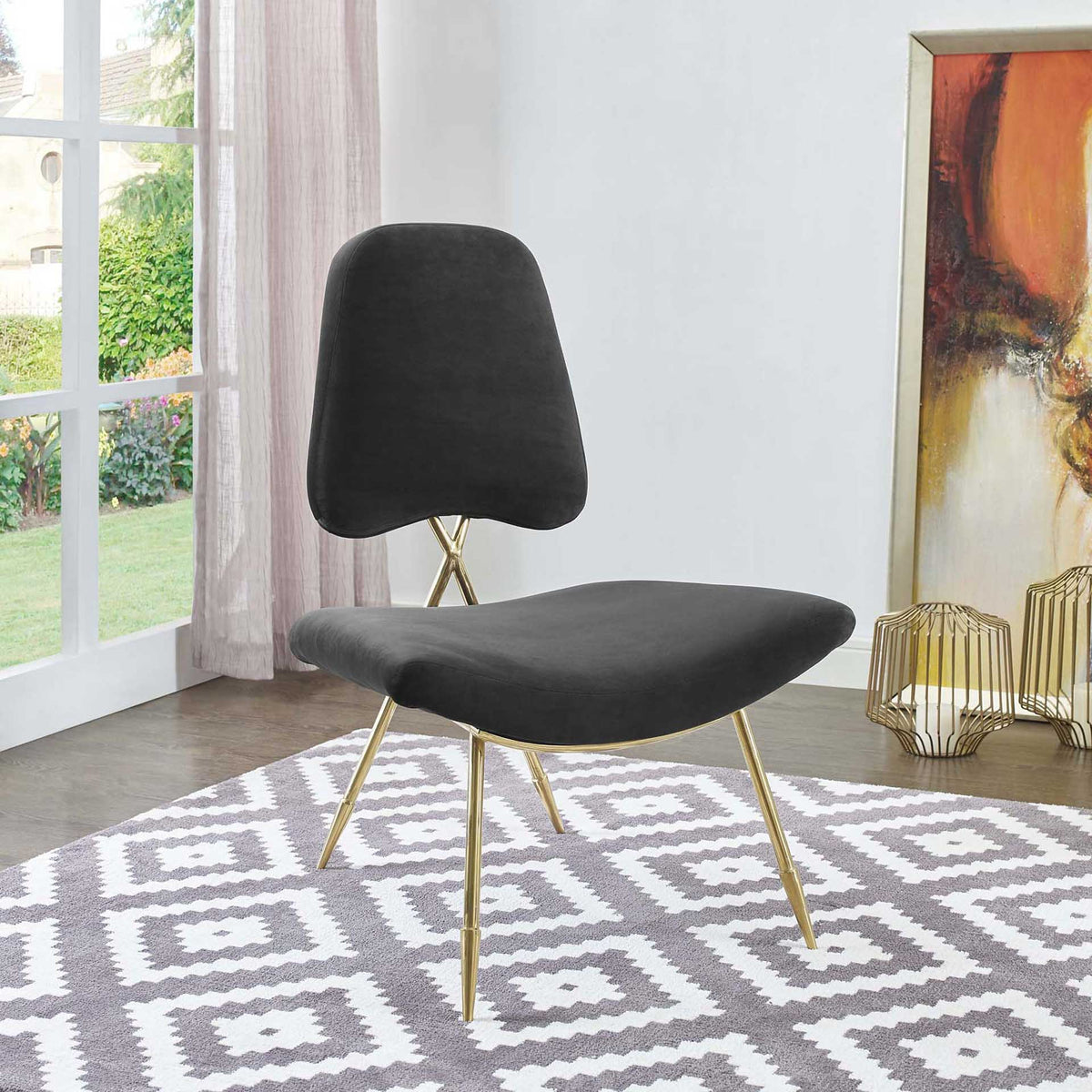 A curved black velvet seat and slim gold legs add modern contrast to this lounge chair.