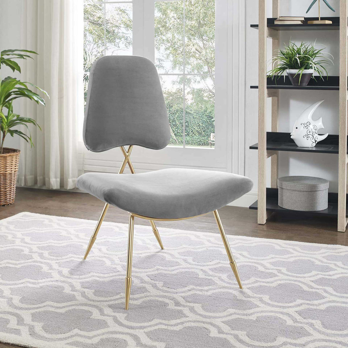 Sculpted gray velvet and slender gold legs create an inviting lounge chair.