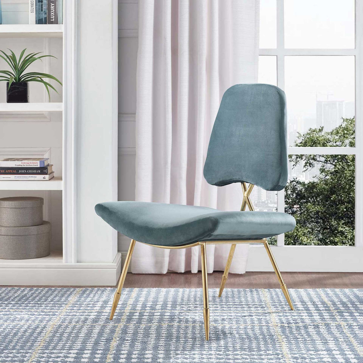 The sculpted sea blue velvet seat brings rich color to a delicate gold frame.