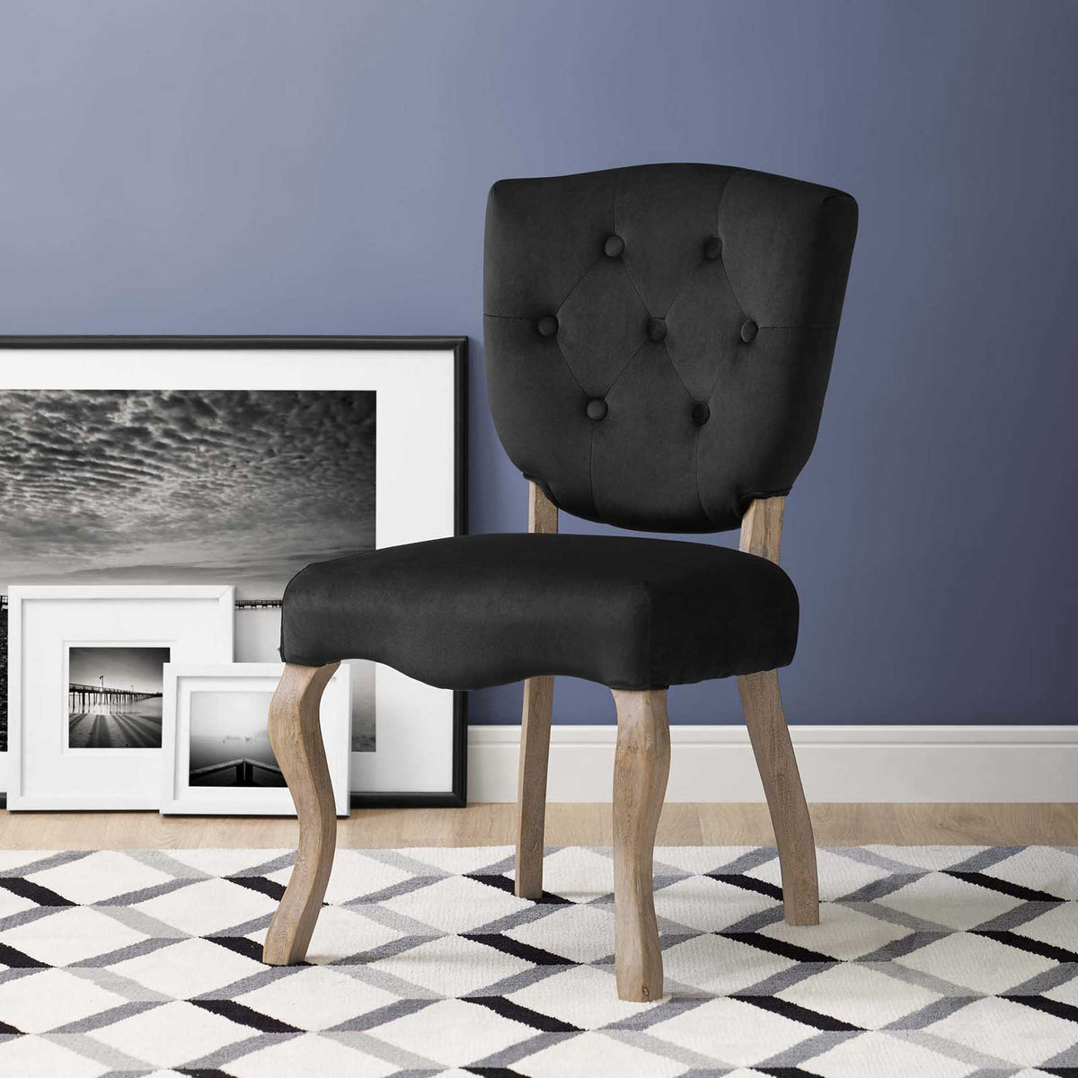 Black button-tufted velvet and graceful wood legs bring vintage charm to this dining chair.