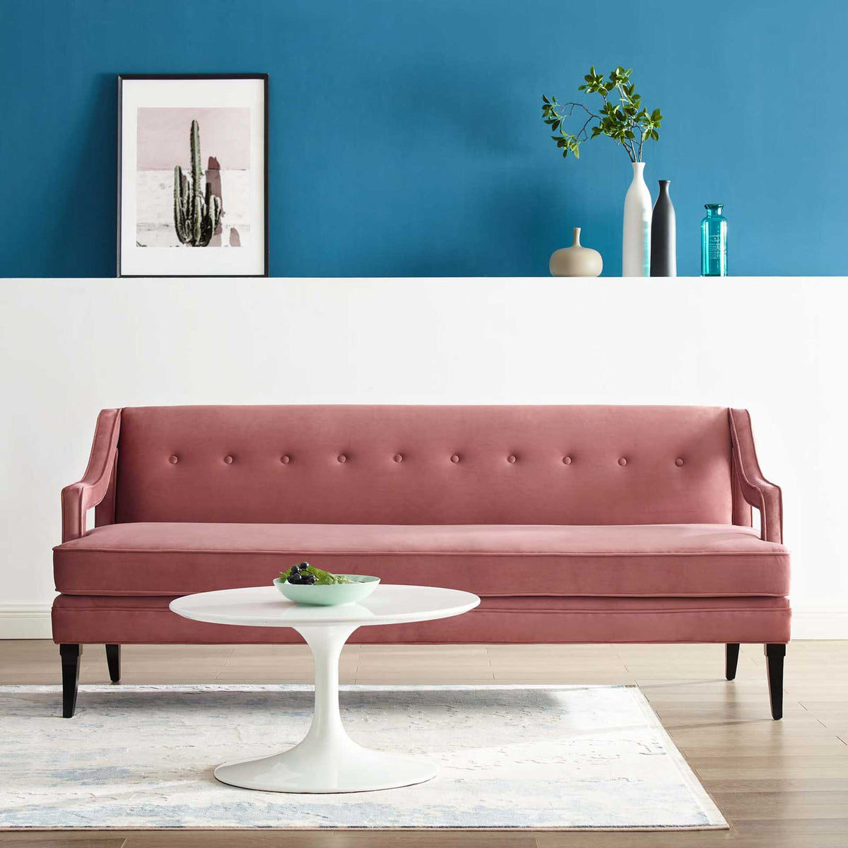 A dusty rose velvet sofa with button tufting and a plush bench seat warms a modern living room