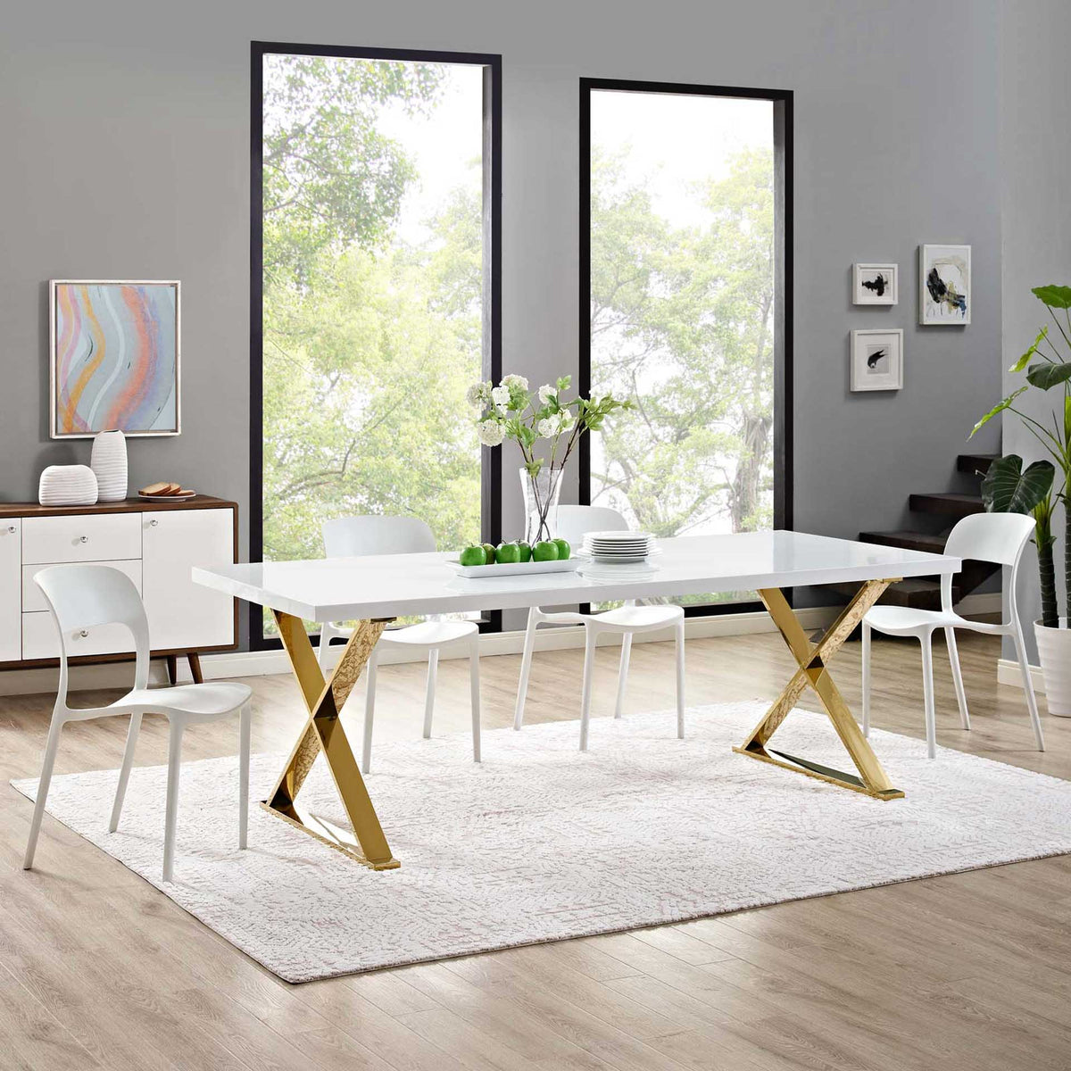 Spacious white and gold dining table offers plenty of room to gather around its sleek top