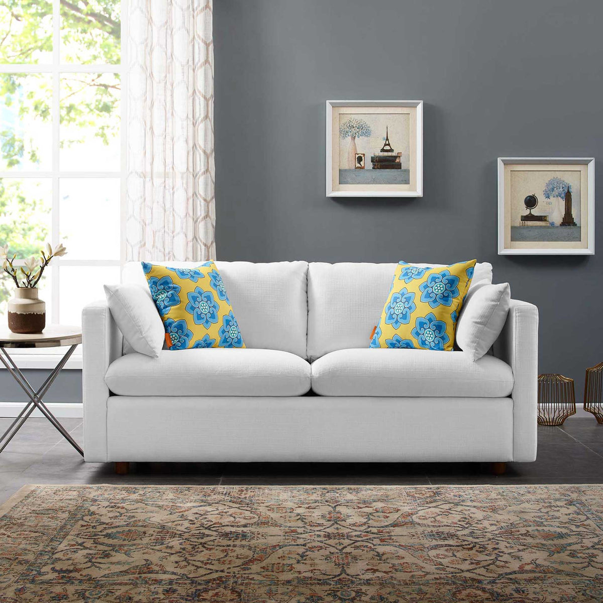 White fabric sofa with soft cushions and slim arms brings inviting comfort to a modern living space