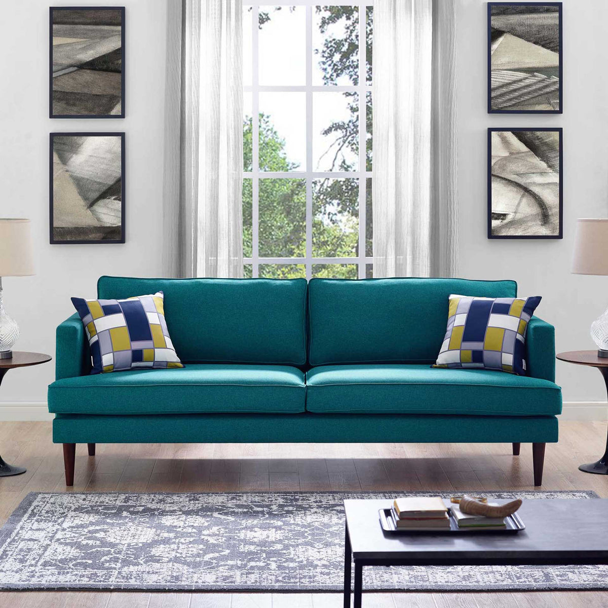 Teal sofa with plush back cushions adds rich color to a bright living room