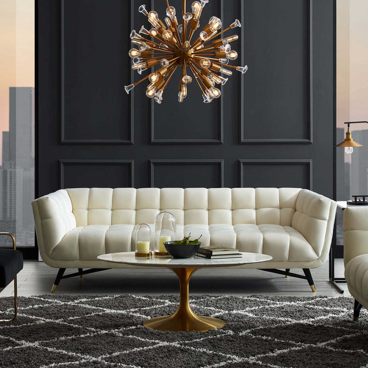 Tufted ivory velvet and gently flared arms create an inviting centerpiece for a modern living room.