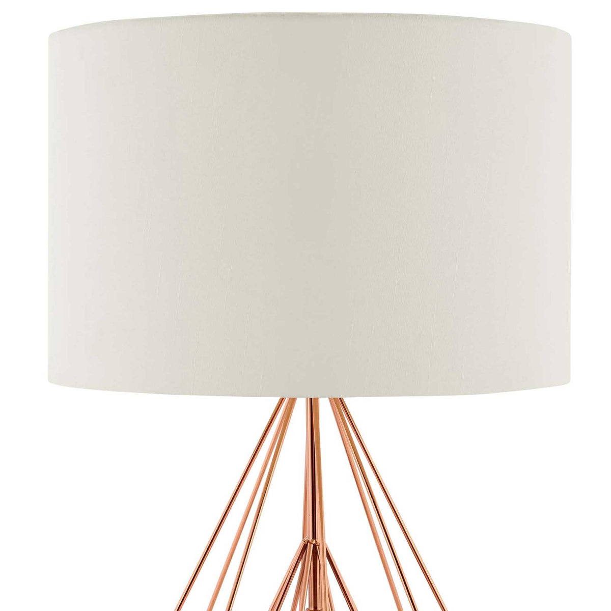 Soft cream fabric gives the drum shade a clean finish above slender rose gold wires.
