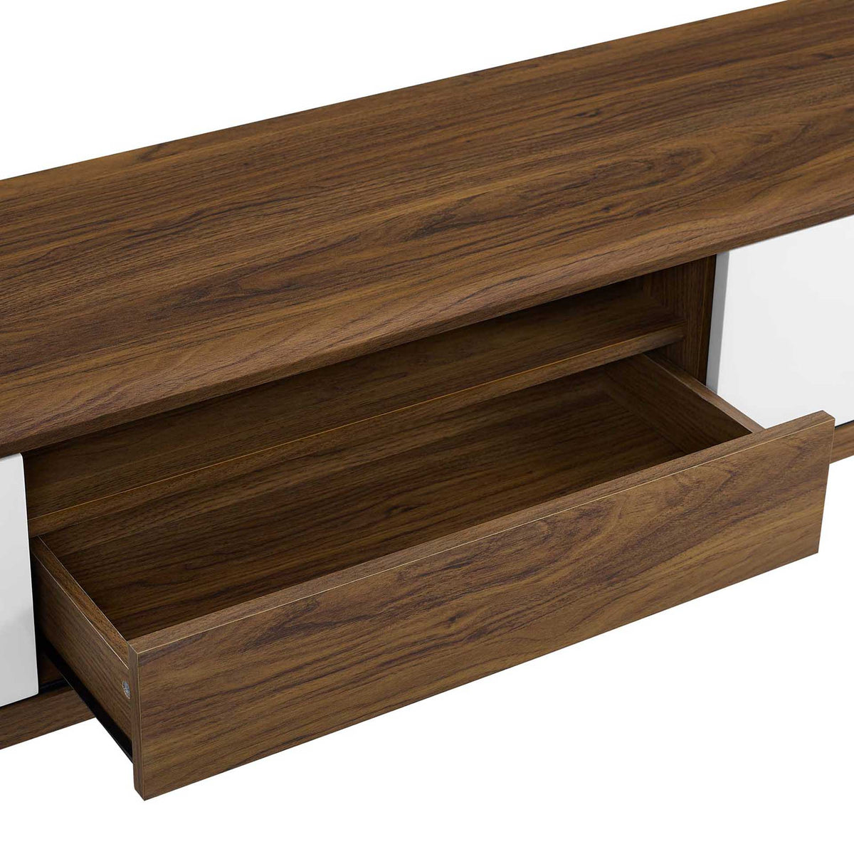Spacious center drawer glides open to reveal ample hidden storage for remotes and media accessories