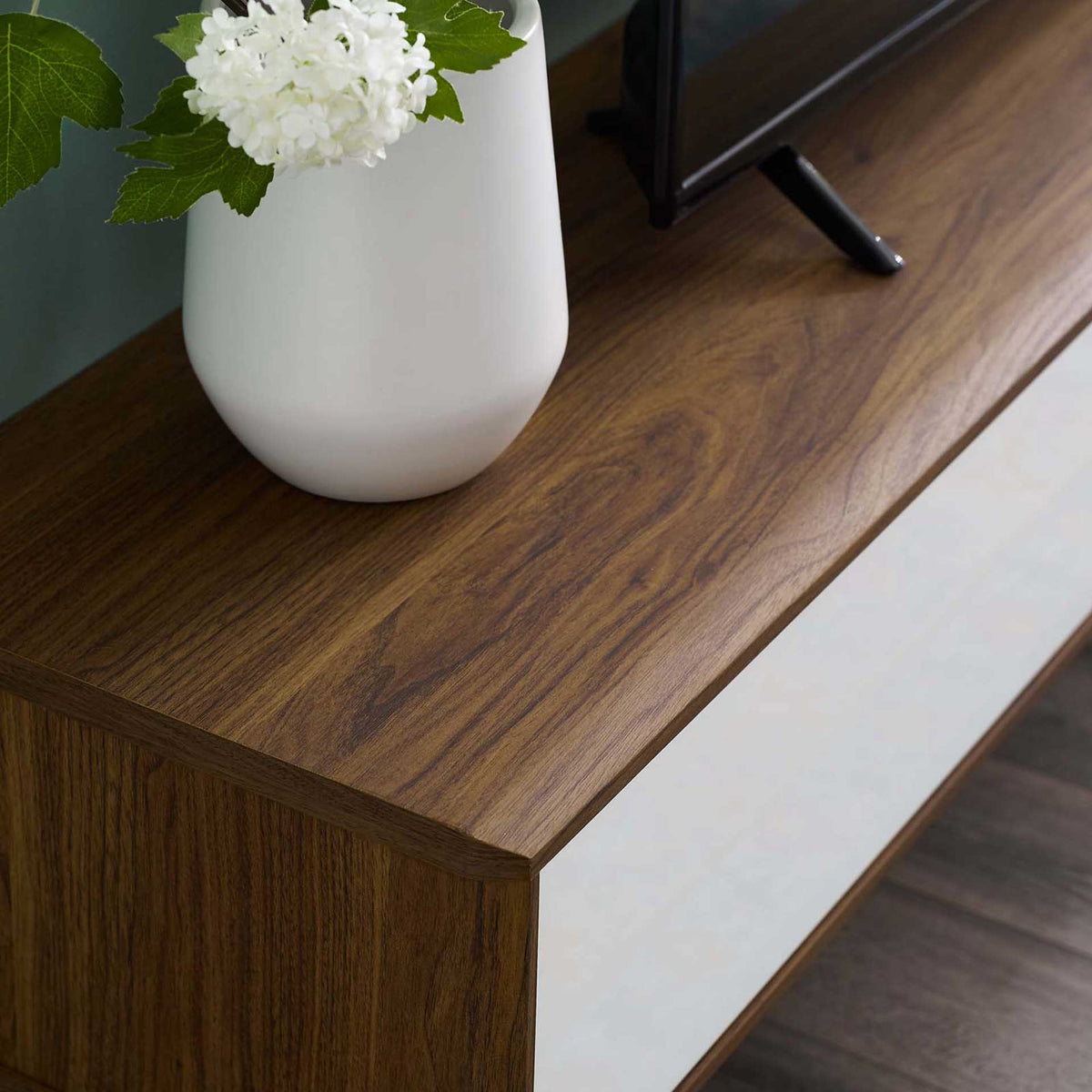 Styled surface displays decor while highlighting the walnut grain and crisp white door front