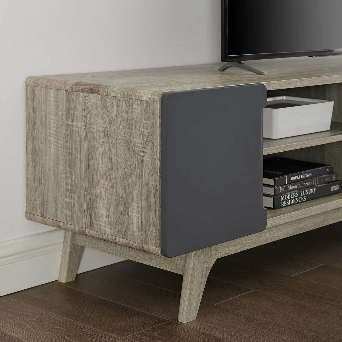 Wood-grain panels, a smooth gray cabinet door, and tapered legs lend warmth to the media console.