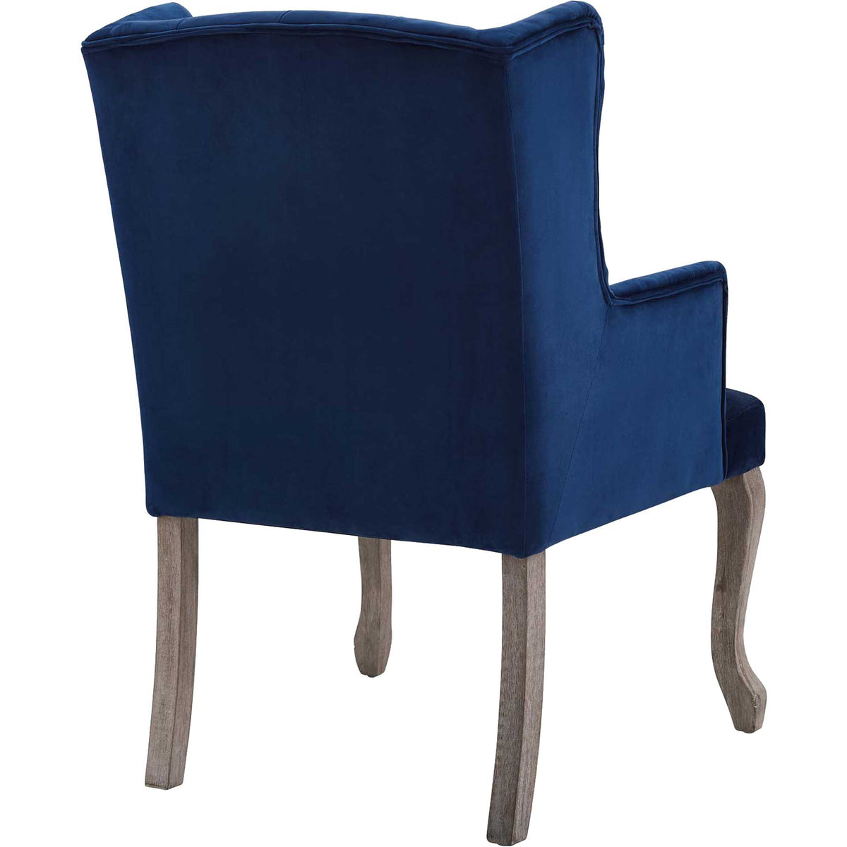 Smooth navy velvet covers the tall wingback above rustic wood legs