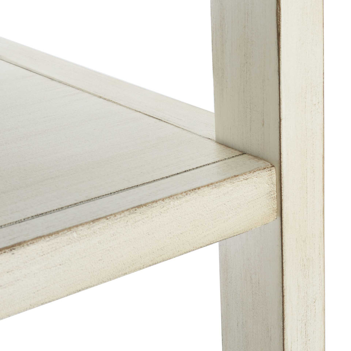 A lightly distressed antique white finish traces the shelf edge and square support post.
