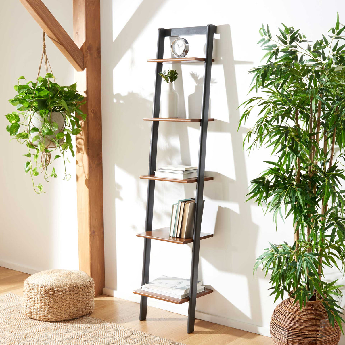 Honey-brown shelves hold books and decor while the charcoal frame adds graphic contrast