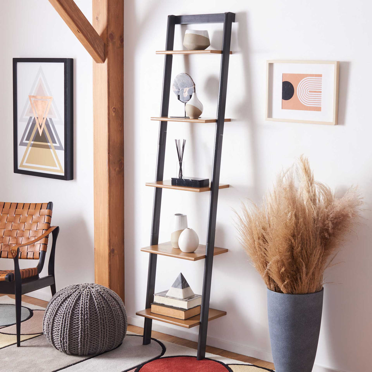 Natural wood shelves showcase ceramics and books with a striking charcoal contrast