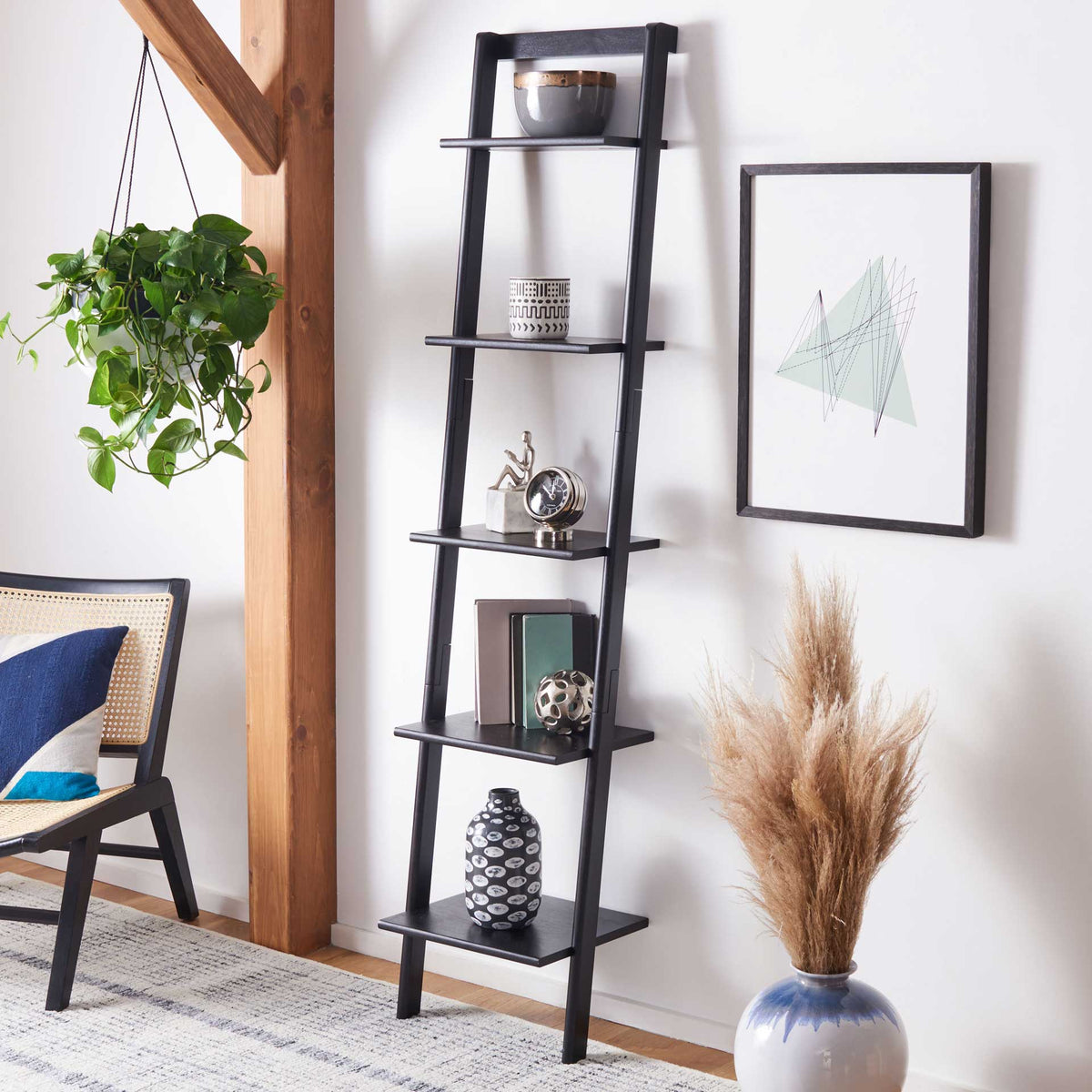 Black leaning shelves organize ceramics, books, and accents in a compact footprint