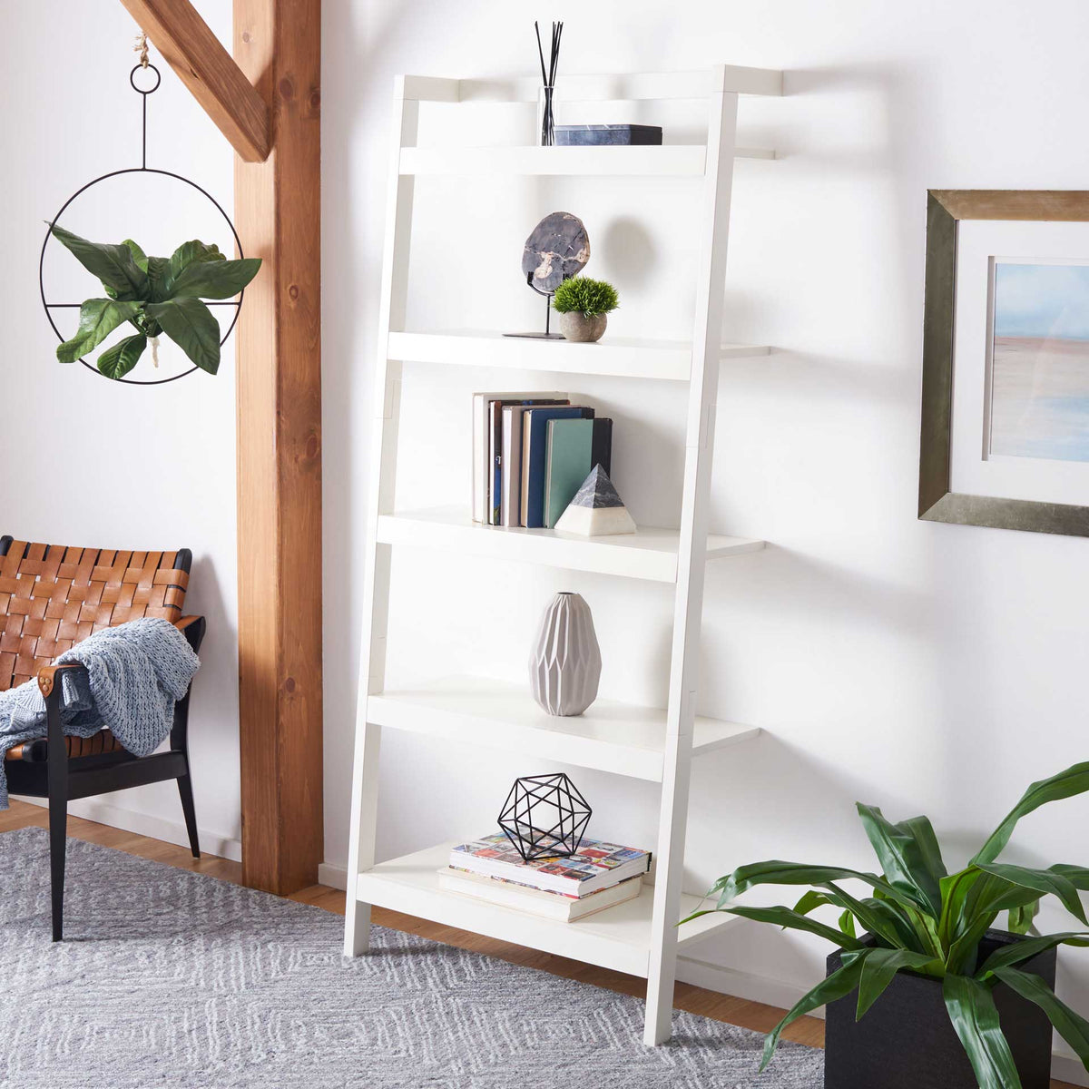 A white five-tier leaning shelf adds airy display space for books, plants, and accents.