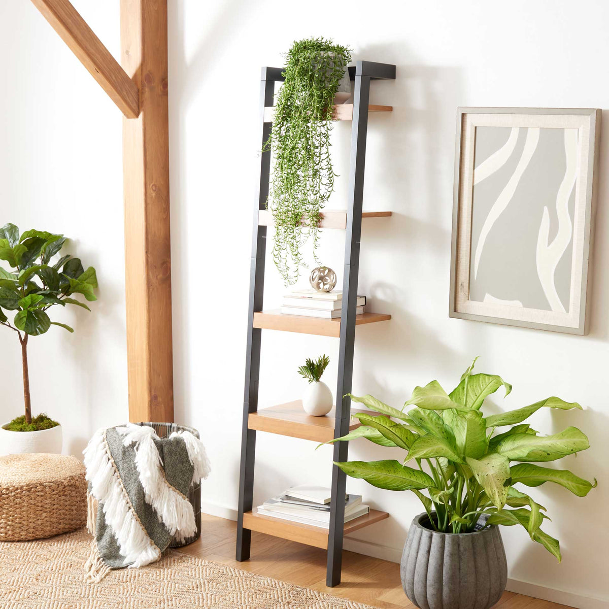 Five natural wood shelves display plants, books and small decor on a charcoal leaning frame.