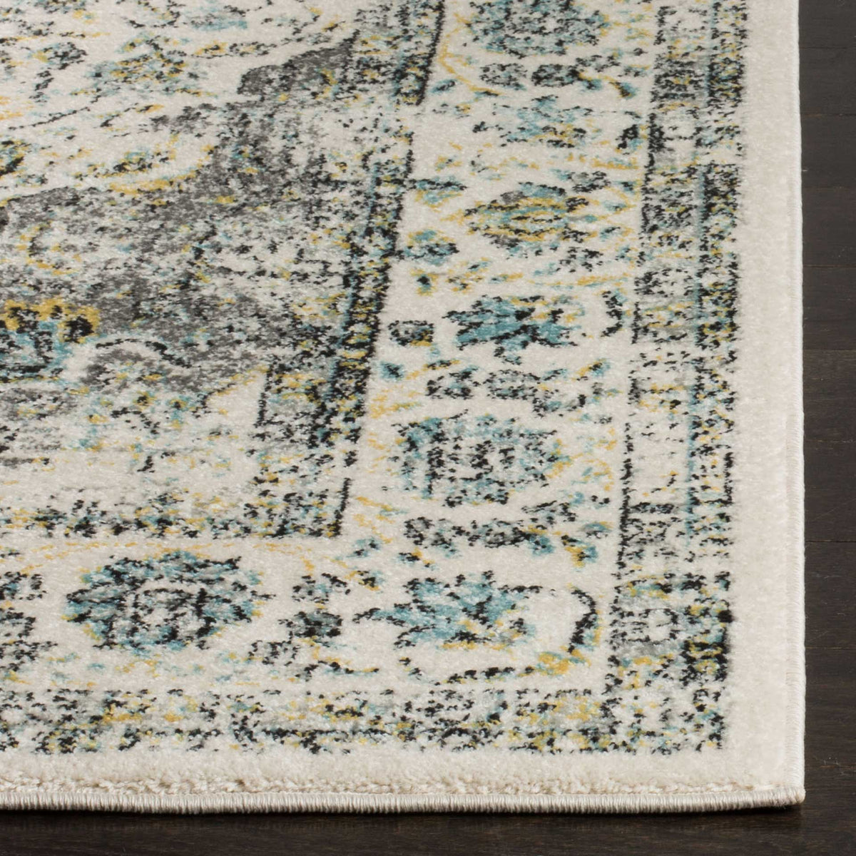 Intricate gray, teal, and gold florals meet a neatly finished edge