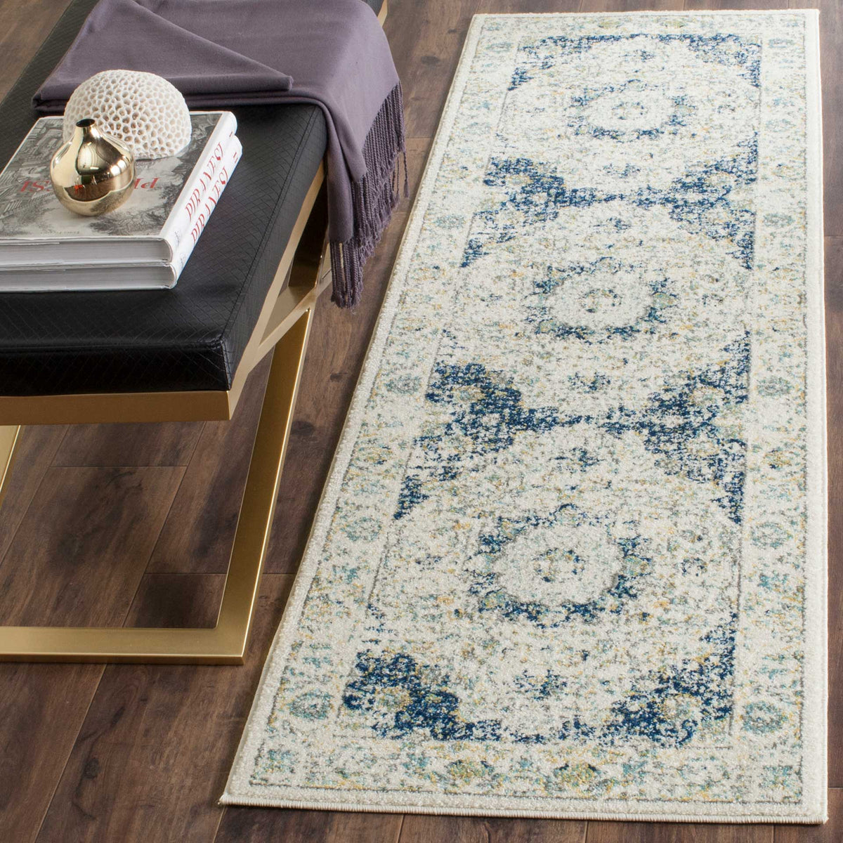 Classic blue medallions stand out against the soft ivory field of this runner rug