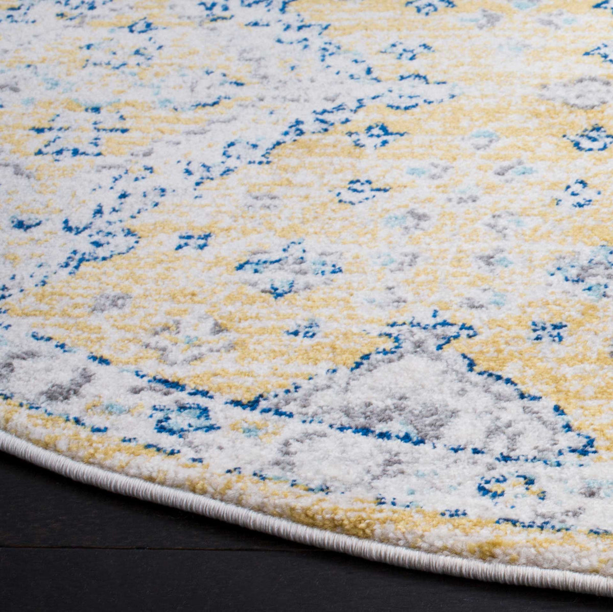 A neatly bound curved edge frames gold and ivory fibers with blue and gray details