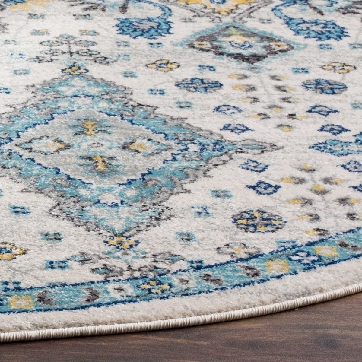 A bound edge and intricate turquoise motifs stand out against the ivory pile