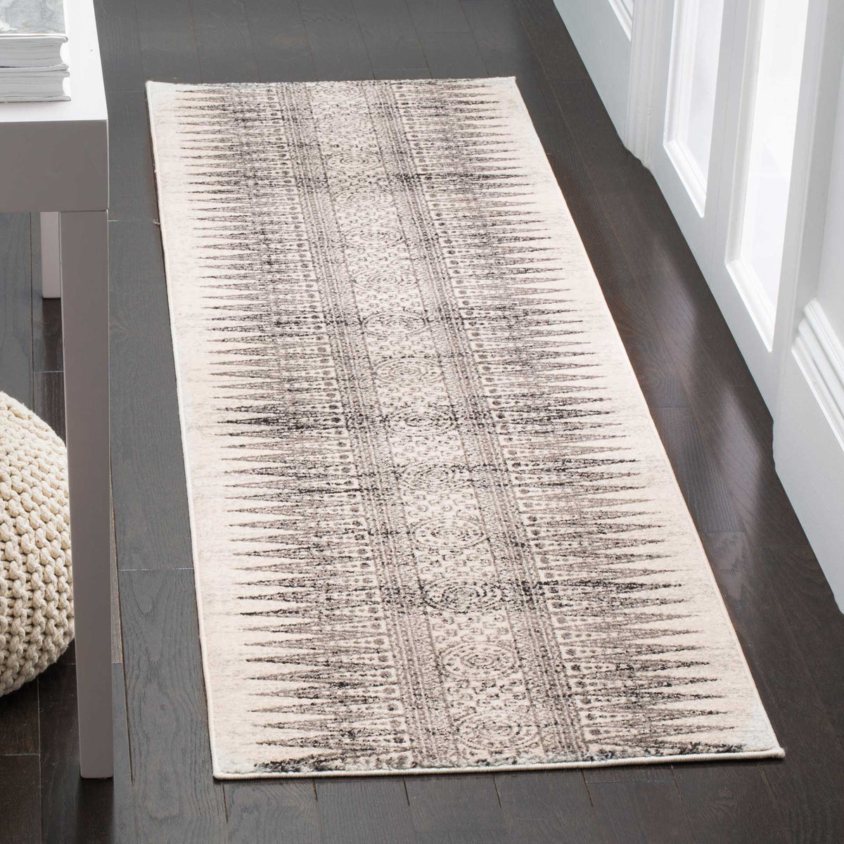 Low-profile ivory and gray runner adds an intricate linear pattern to hallways and entryways