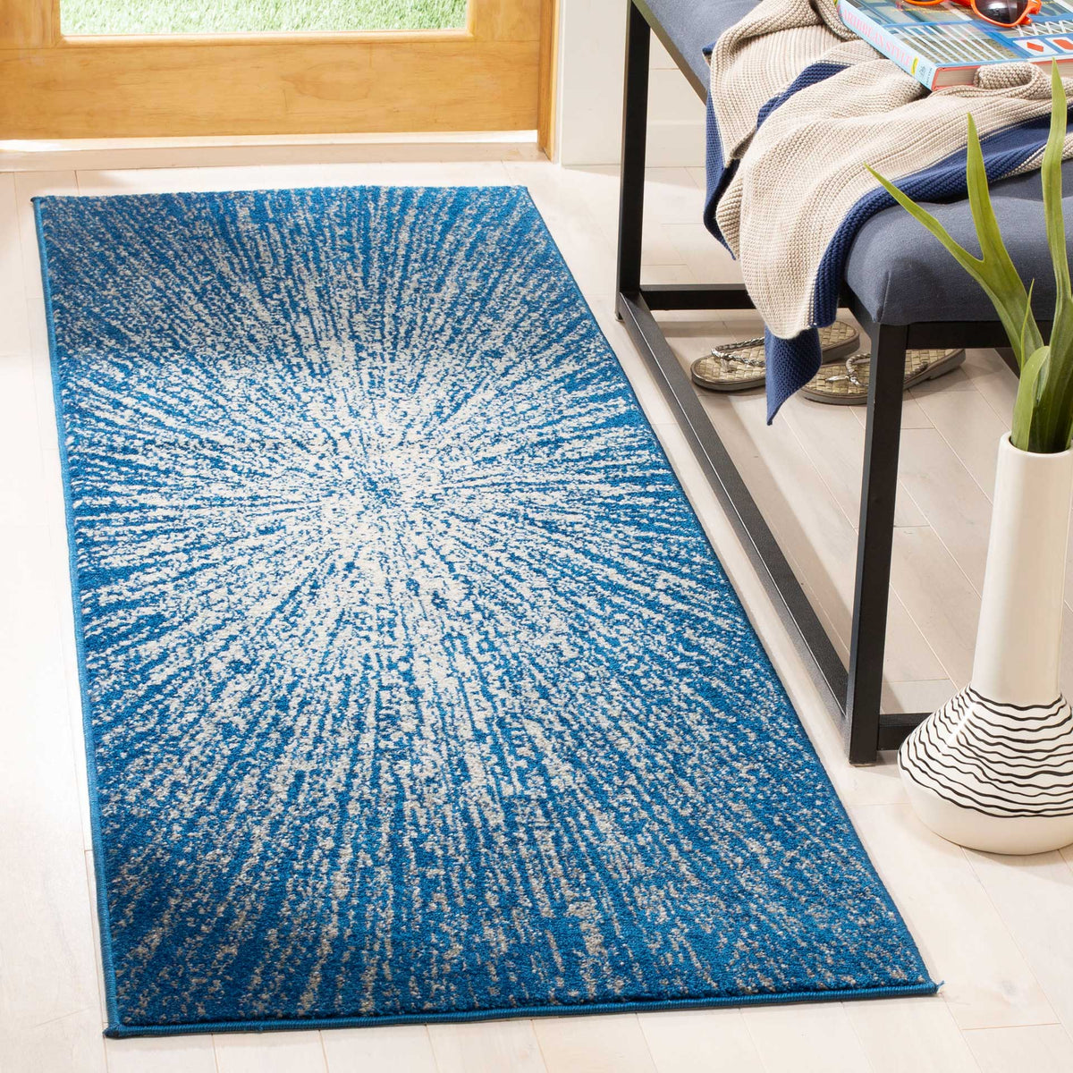A crisp ivory burst radiates through rich navy blue on this runner rug.