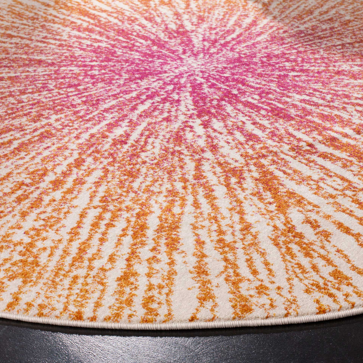Fine fuchsia and orange streaks reveal textured pile and a neatly bound edge