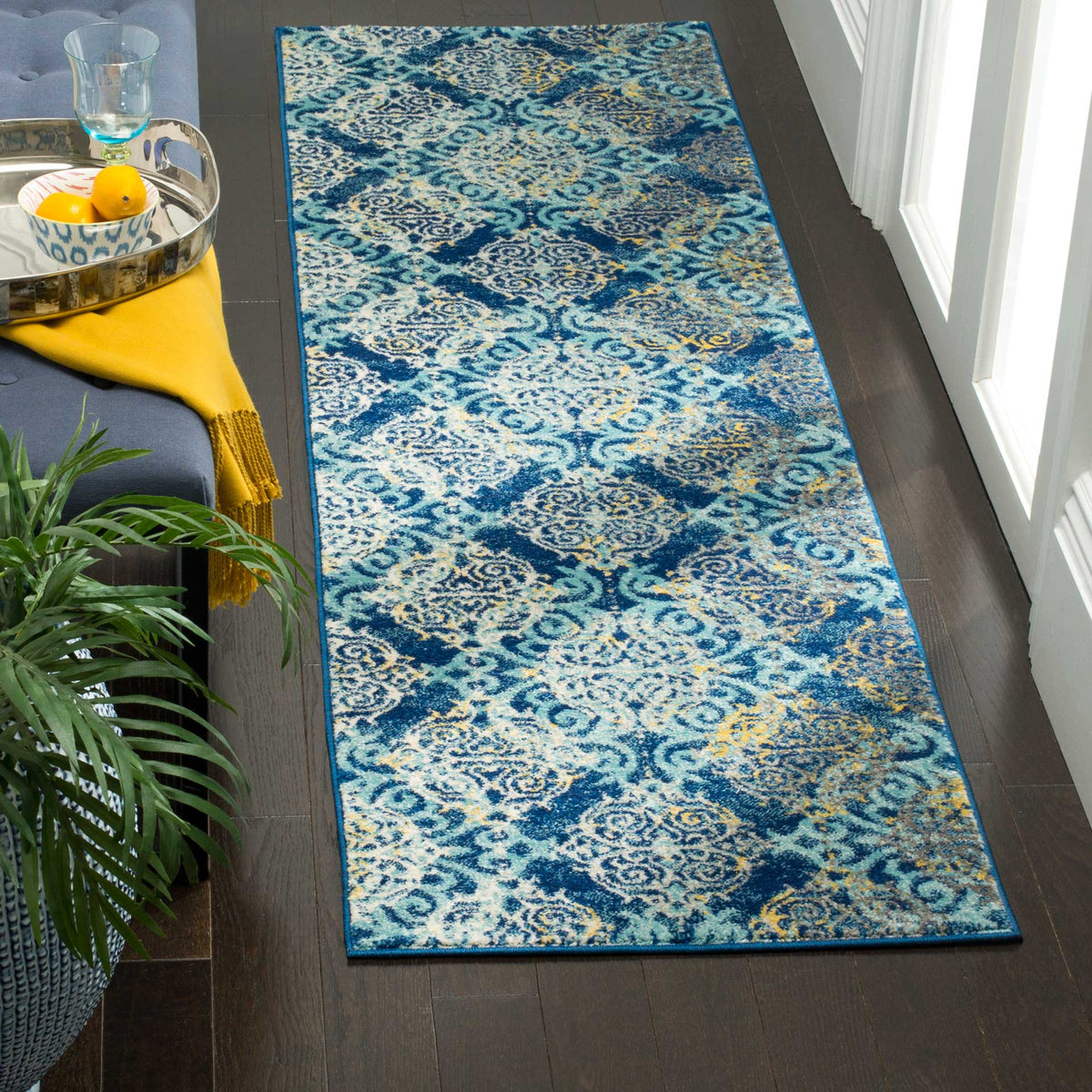 Swirling pale blue and ivory paisley motifs brighten a richly colored blue runner