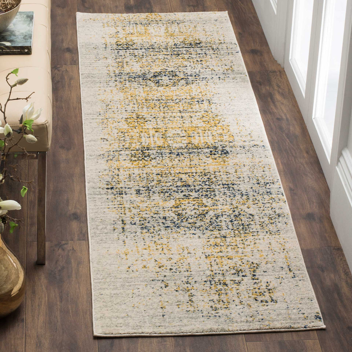 An ivory runner with mottled blue and gold detailing adds warmth to a wood-floored hallway