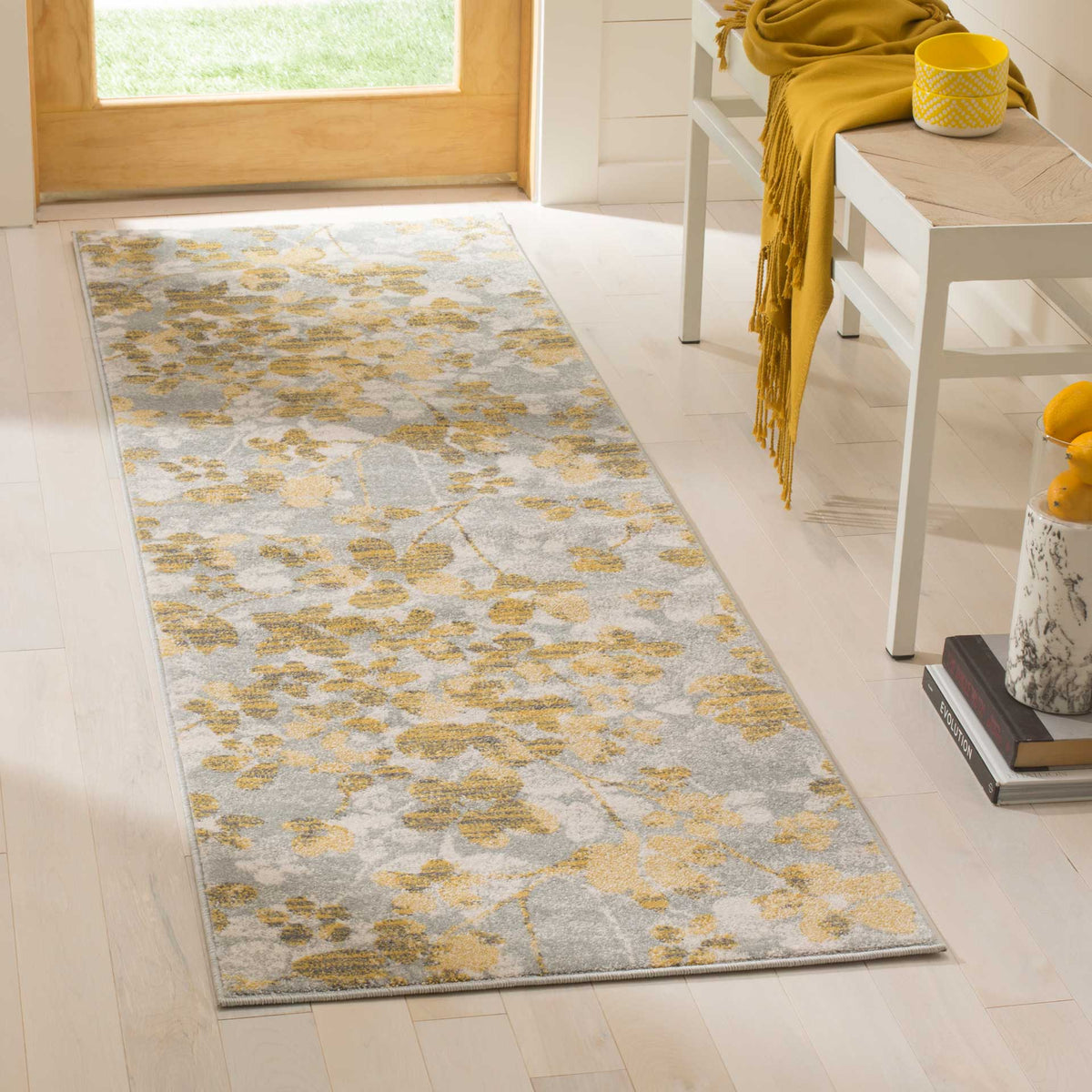 Gold flowers and delicate stems enliven the gray ground of this narrow runner rug