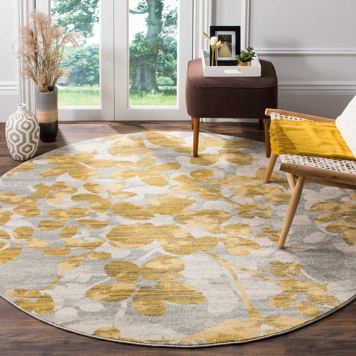 Gray and gold floral rug brings warm color and soft texture to a seating area