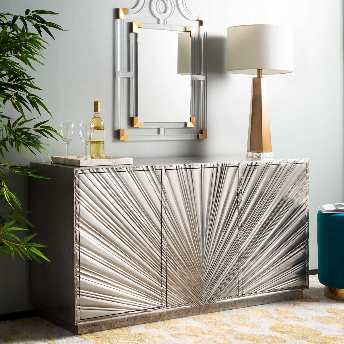 Golden floral motifs lend warmth to the gray rug beneath metallic furnishings