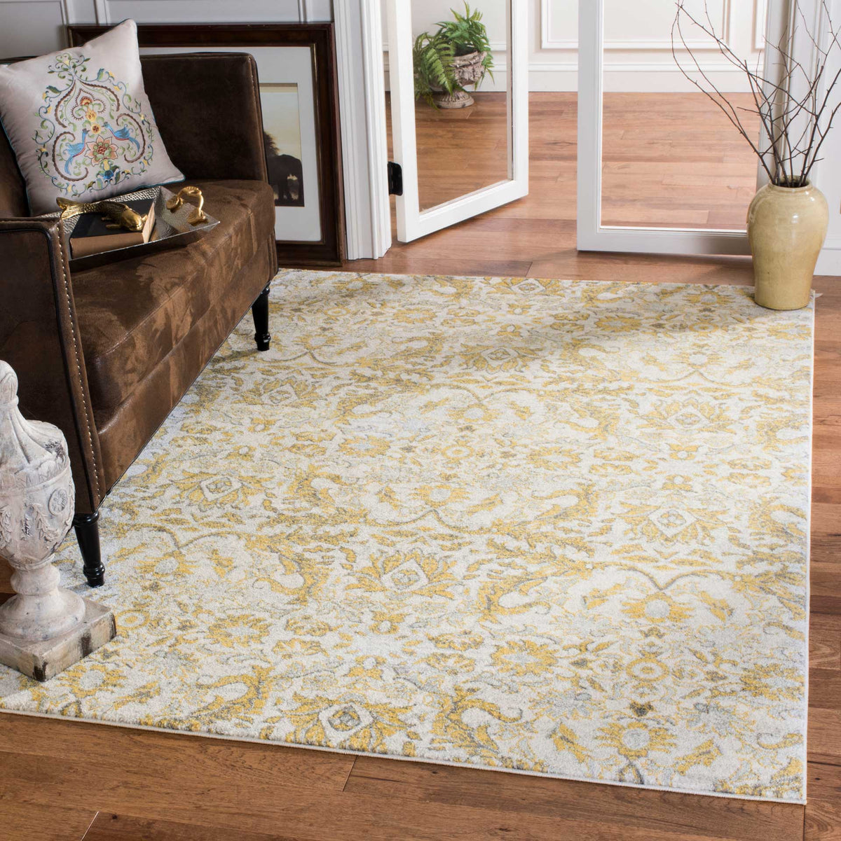 Ornate ivory and gold florals bring inviting warmth beneath living room furnishings