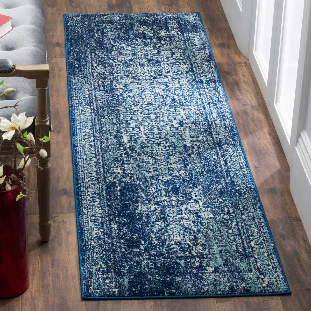 Navy and ivory runner adds striking contrast and vintage-inspired detail to a wood floor