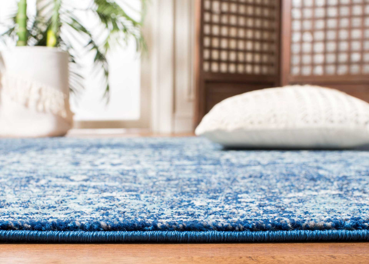 Low, textured navy and ivory pile brings soft pattern and comfort underfoot