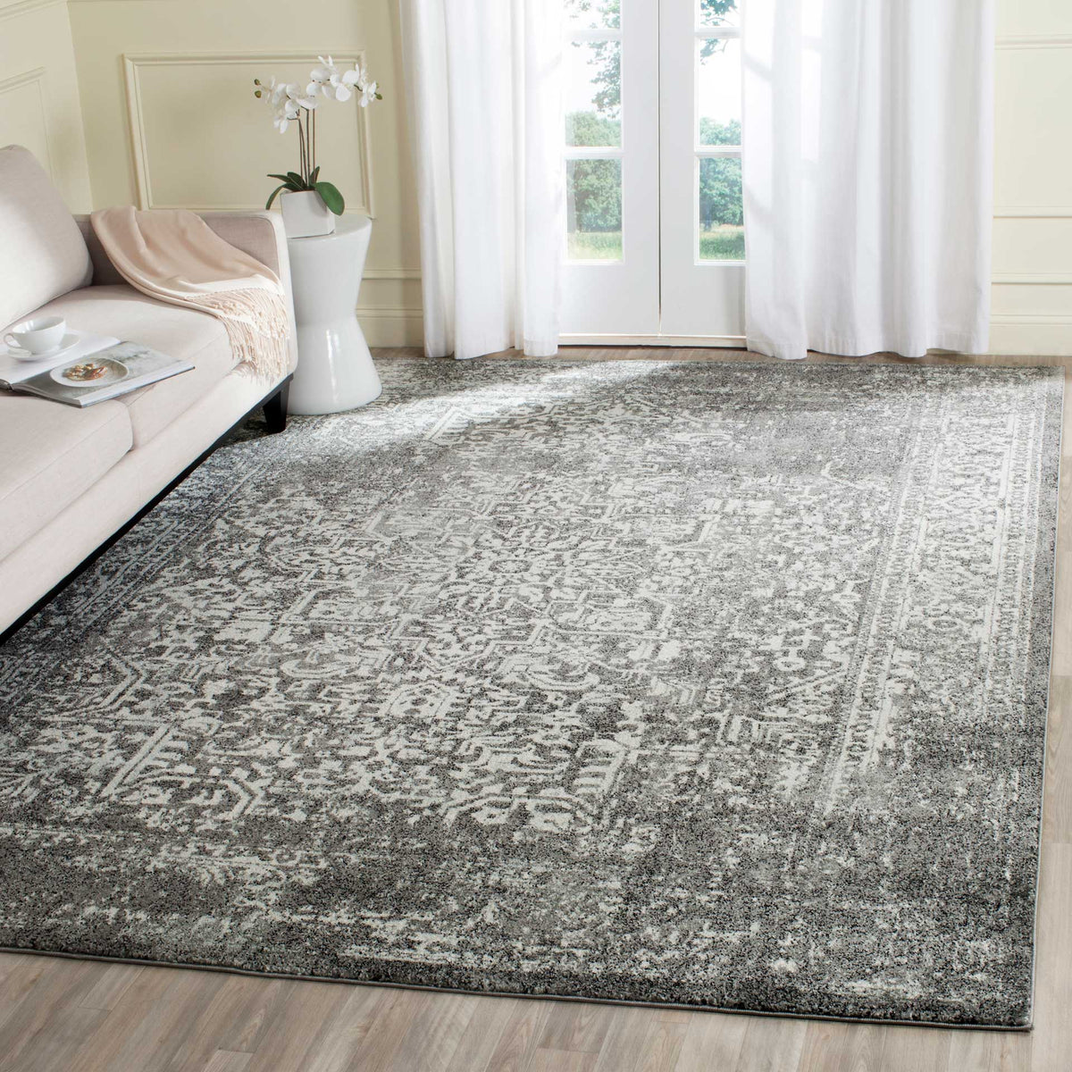 Distressed gray and ivory rug lends classic character to a light-filled living space