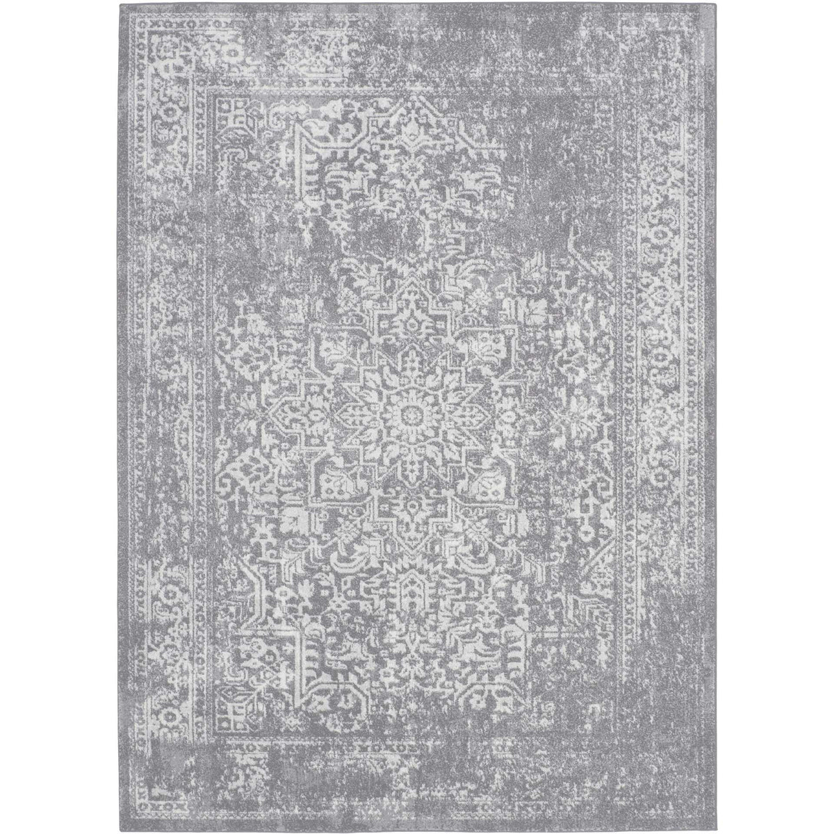 Soft silver and ivory rug shows an intricate floral medallion with gently faded edges