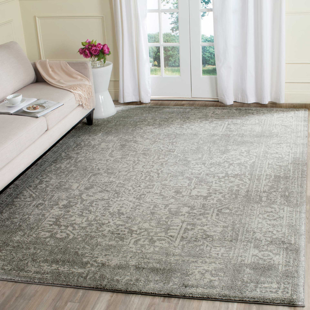 Silver and ivory rug brings a softly faded traditional design to a sunlit living room
