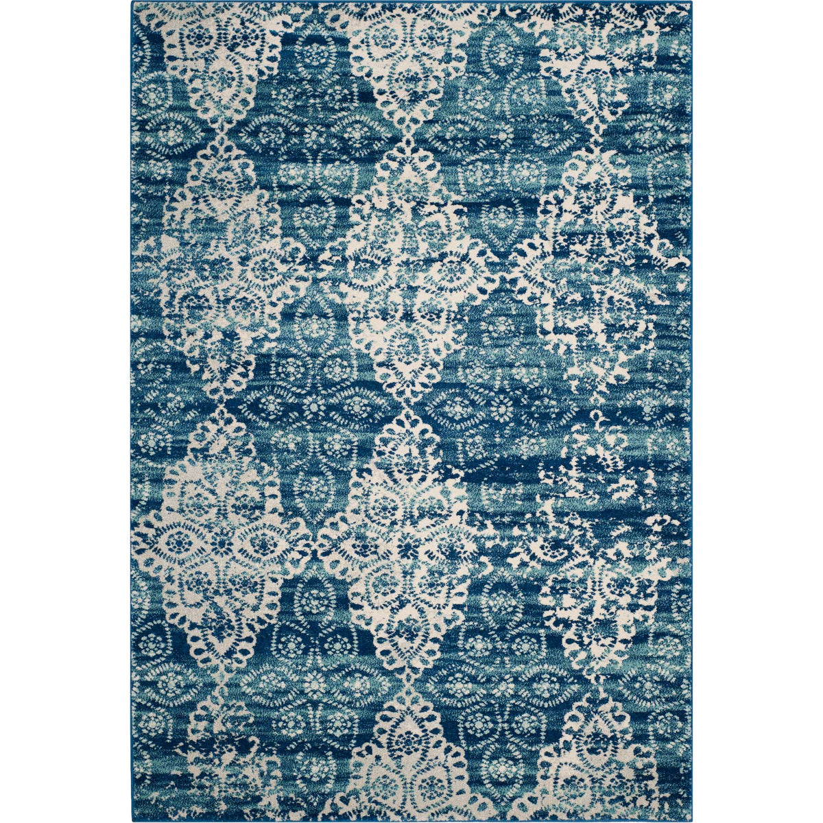 Rectangular blue rug layered with ivory lace-like motifs and weathered floral details