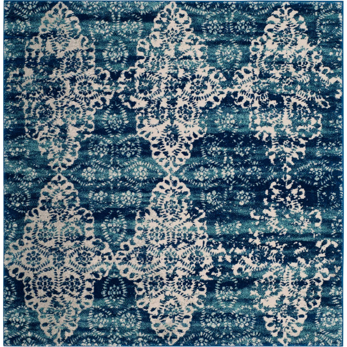 Square royal blue rug with bold ivory medallions and softly faded botanical flourishes