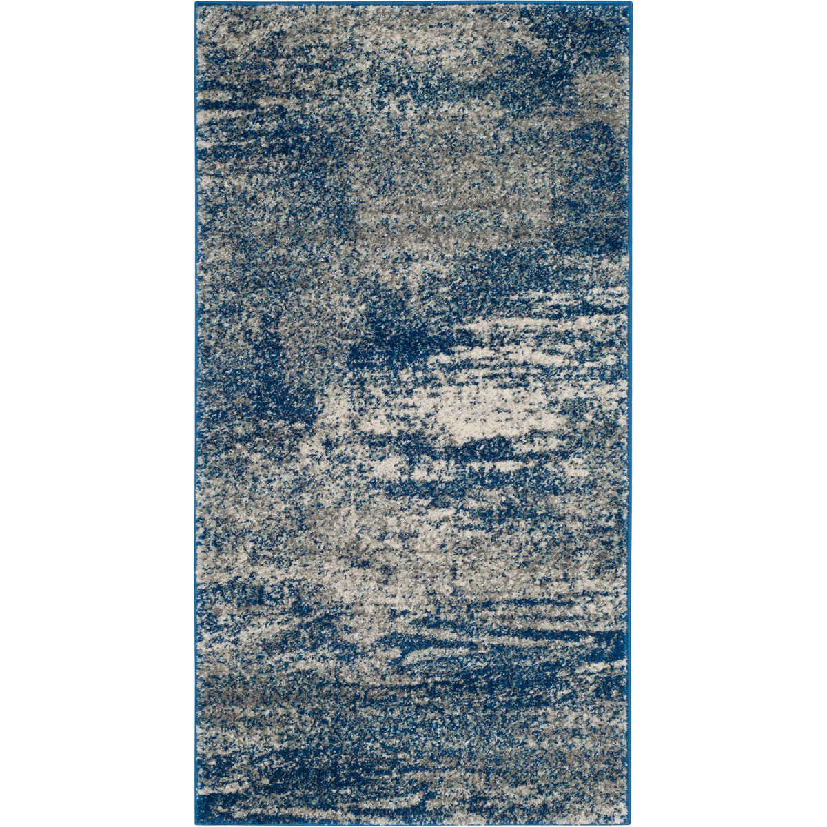 A compact navy and ivory accent rug brings painterly movement and soft contrast to the floor.