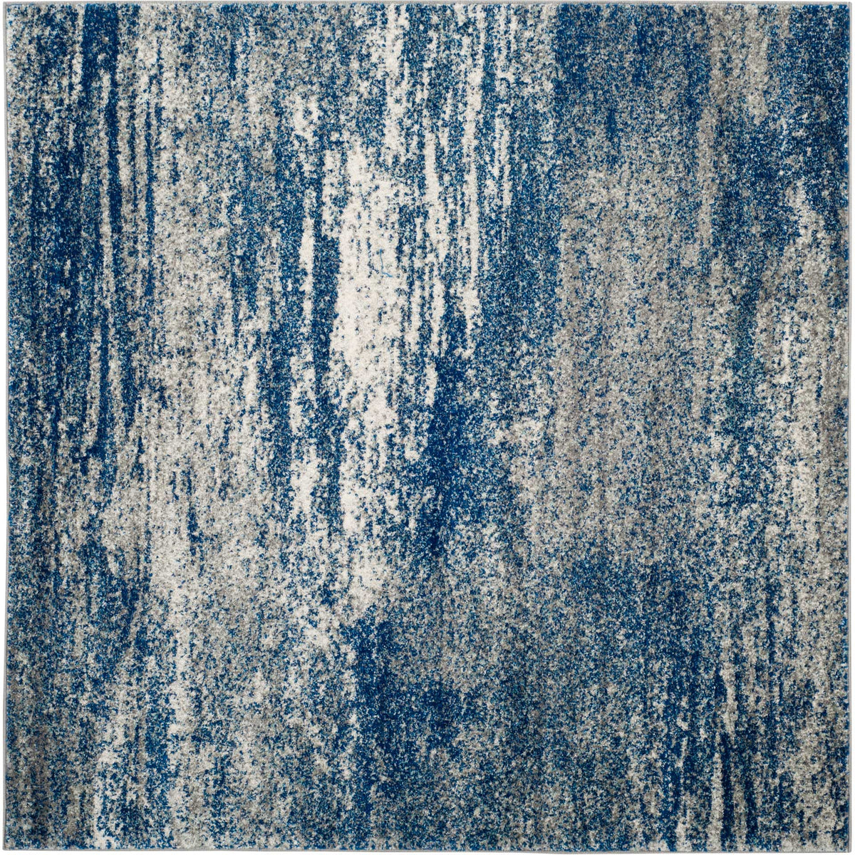 A square navy and ivory rug features cascading abstract streaks and rich tonal texture.